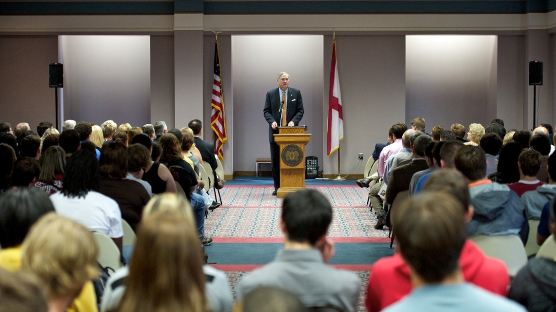 Alabama Attorney General Luther Strange towers behind the podium while addressing the audience at the 2011 Constitution Day Celebration.